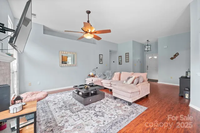 a living room with furniture rug and wooden floor