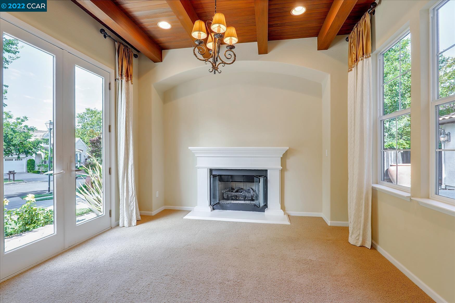 109 Elegans Court San Ramon, CA 94582 - Photo 14 of 41 a view of a livingroom with a fireplace large windows and outside view