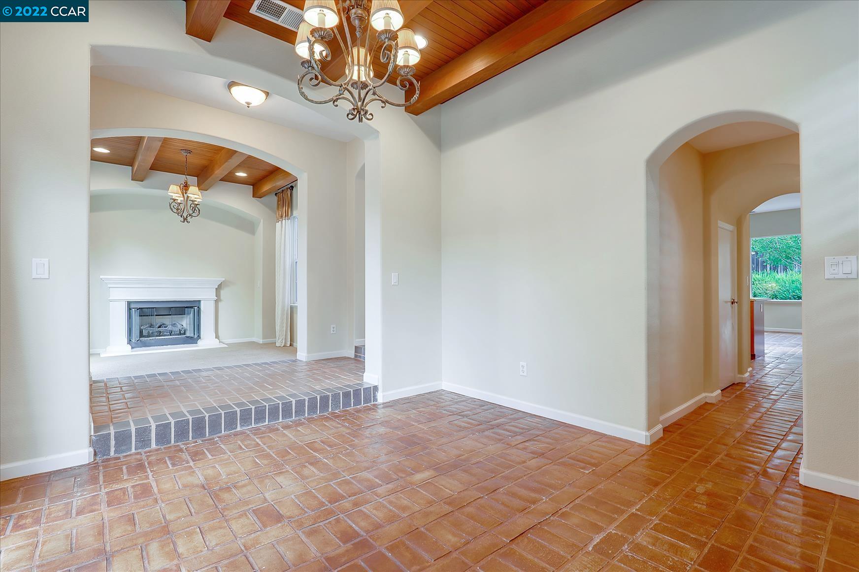 109 Elegans Court San Ramon, CA 94582 - Photo 15 of 41 a view of a hallway with a chandelier fan and wooden floor