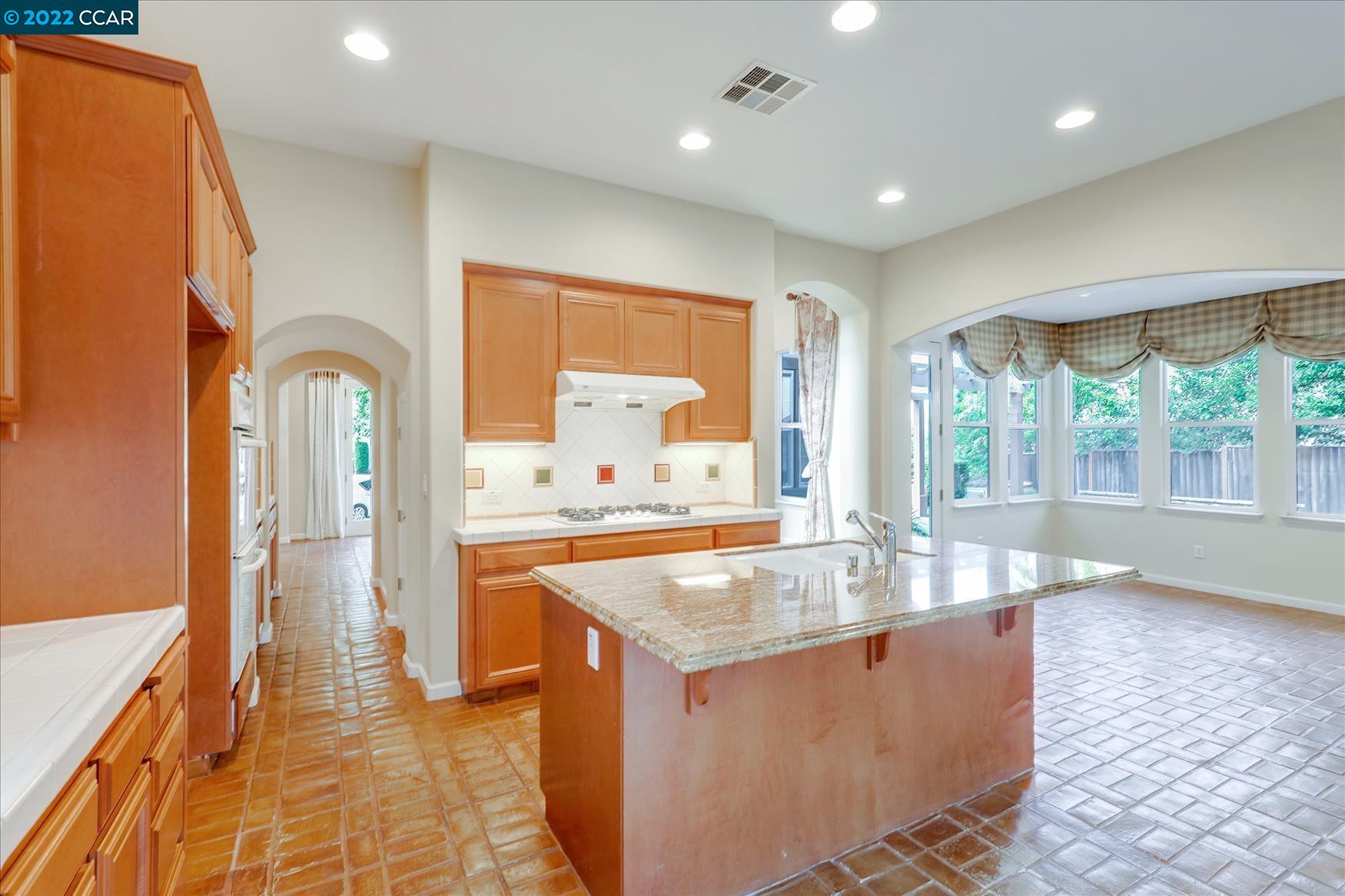 109 Elegans Court San Ramon, CA 94582 - Photo 22 of 41 a living room with granite countertop furniture a fireplace and a large window