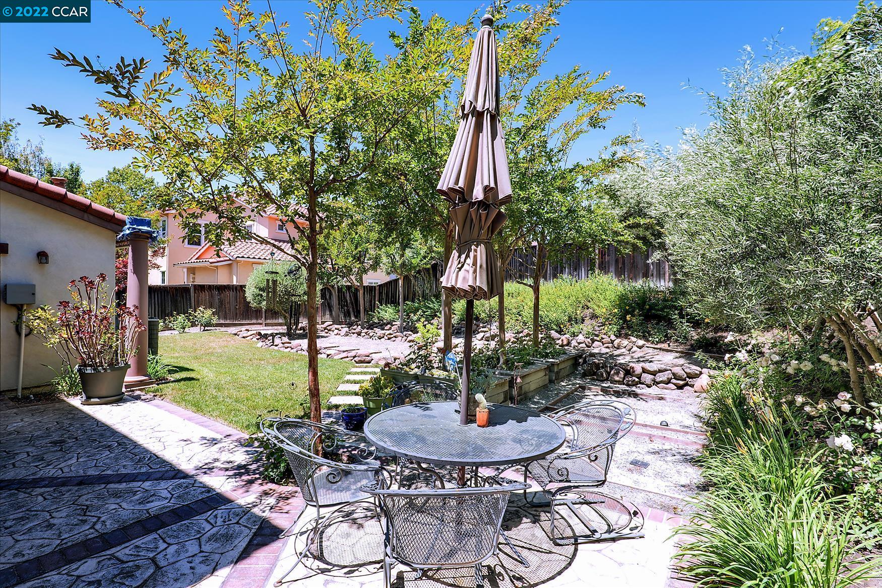 109 Elegans Court San Ramon, CA 94582 - Photo 10 of 41 a view of a patio with table and chairs potted plants and large tree