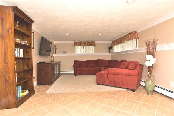 133 Spring Street Stoneham, MA 02180 - Photo 14 of 20 a living room with furniture and a kitchen view