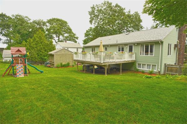 133 Spring Street Stoneham, MA 02180 - Photo 2 of 20 a view of a house with a backyard and a patio