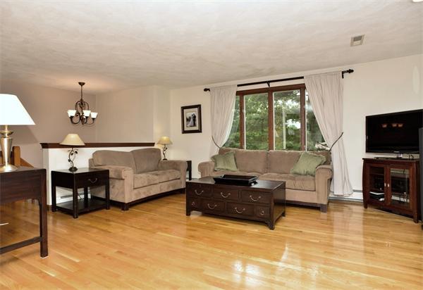133 Spring Street Stoneham, MA 02180 - Photo 3 of 20 a living room with furniture and a flat screen tv