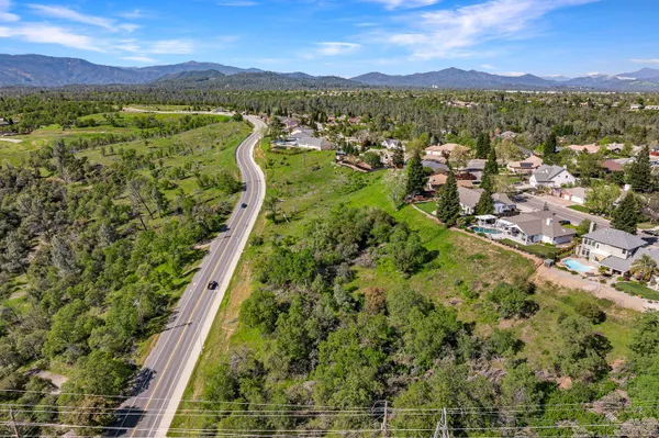 a view of a green field with a city view