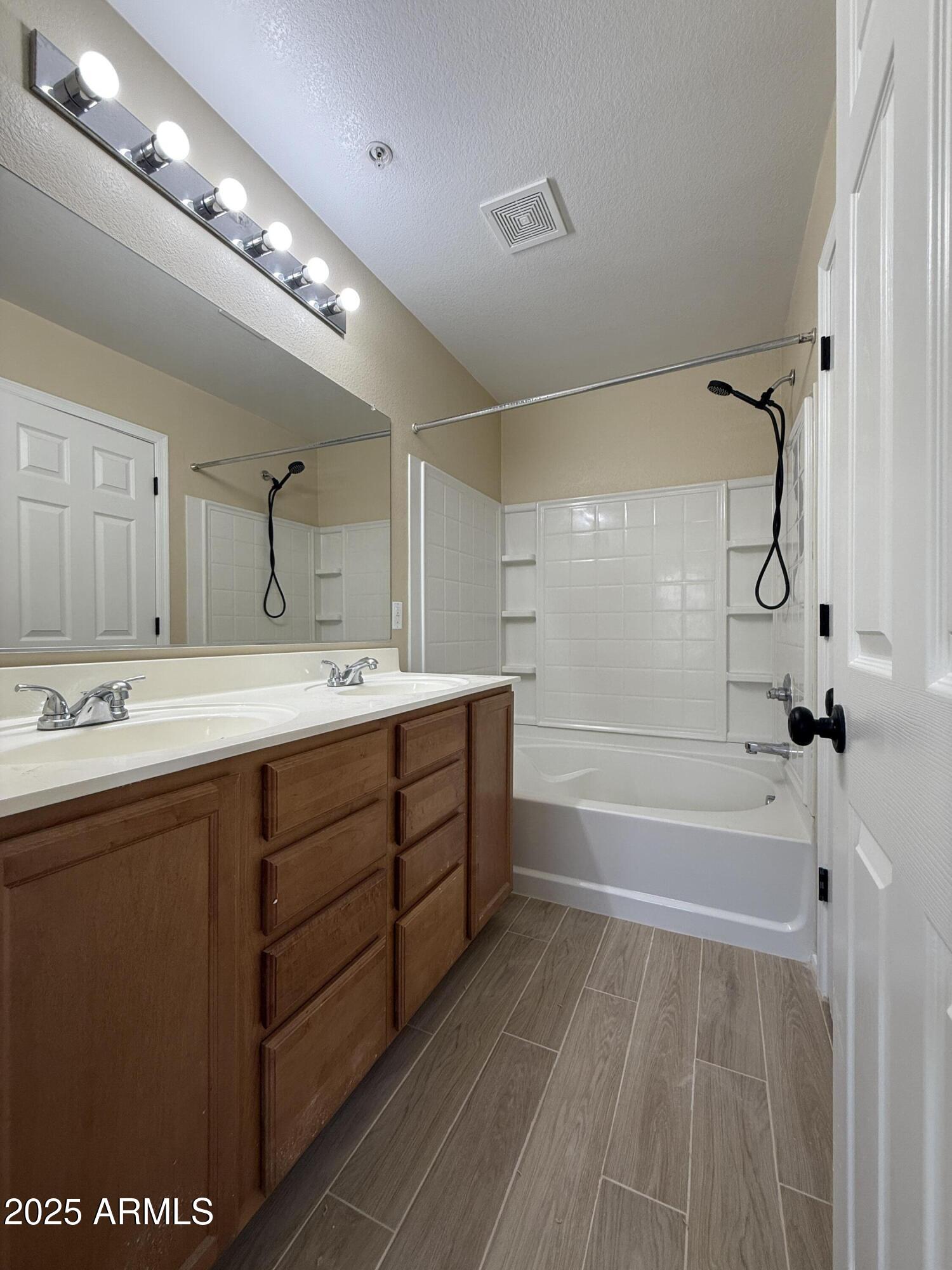 1265 South Aaron, Unit 277 Mesa, AZ 85209 - Photo 11 of 37 a spacious bathroom with a double vanity sink a mirror and a bathtub