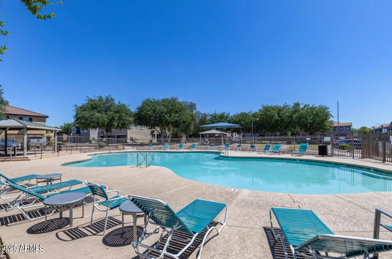 1265 South Aaron, Unit 277 Mesa, AZ 85209 - Photo 18 of 37 a view of a swimming pool and lounge chairs