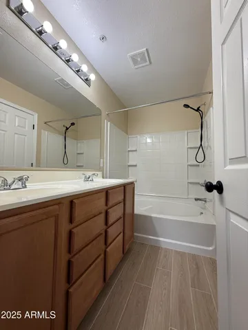 a view of a hallway with wooden cabinets