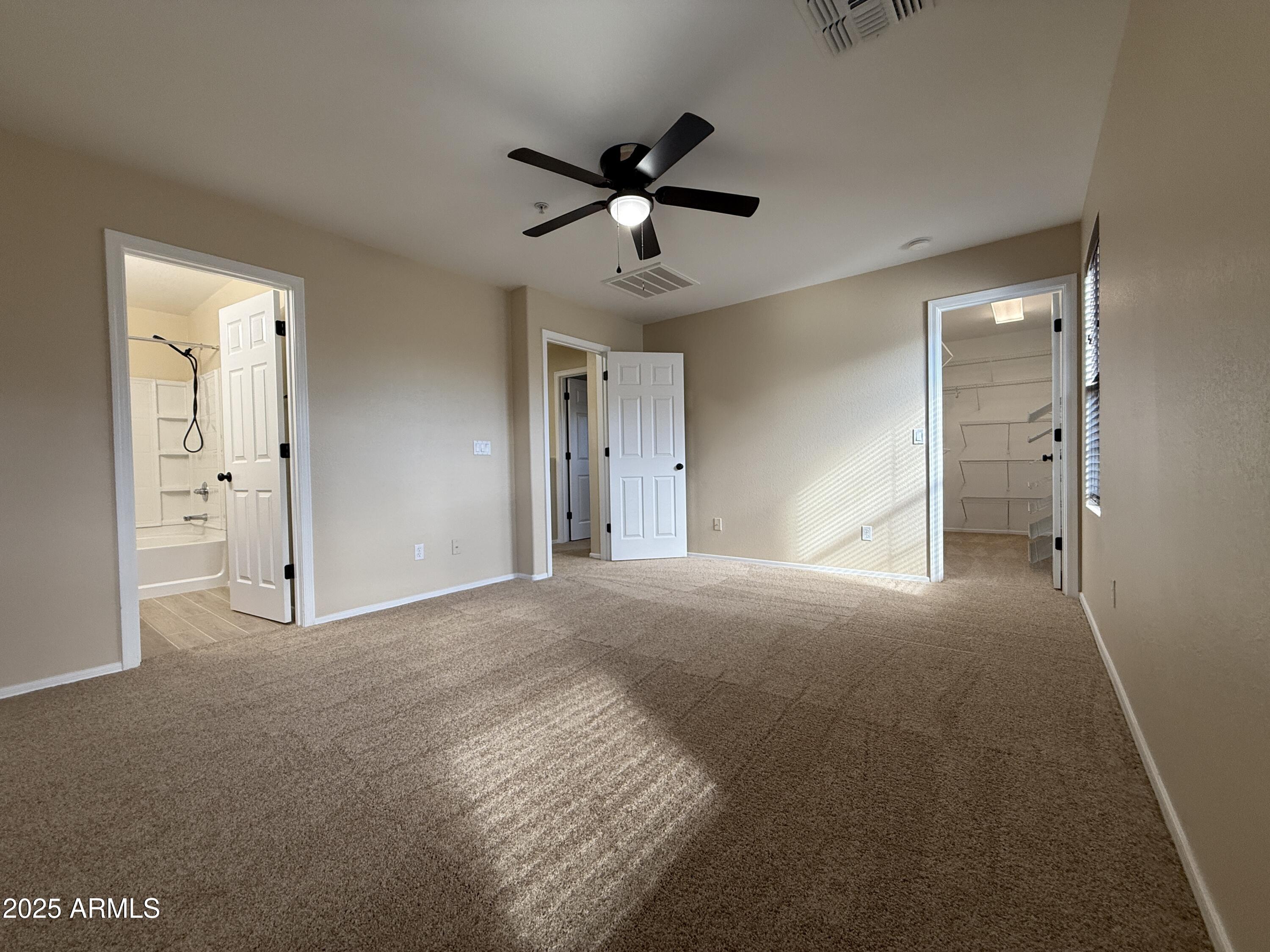 1265 South Aaron, Unit 277 Mesa, AZ 85209 - Photo 26 of 37 a view of empty room with wooden floor and ceiling fan