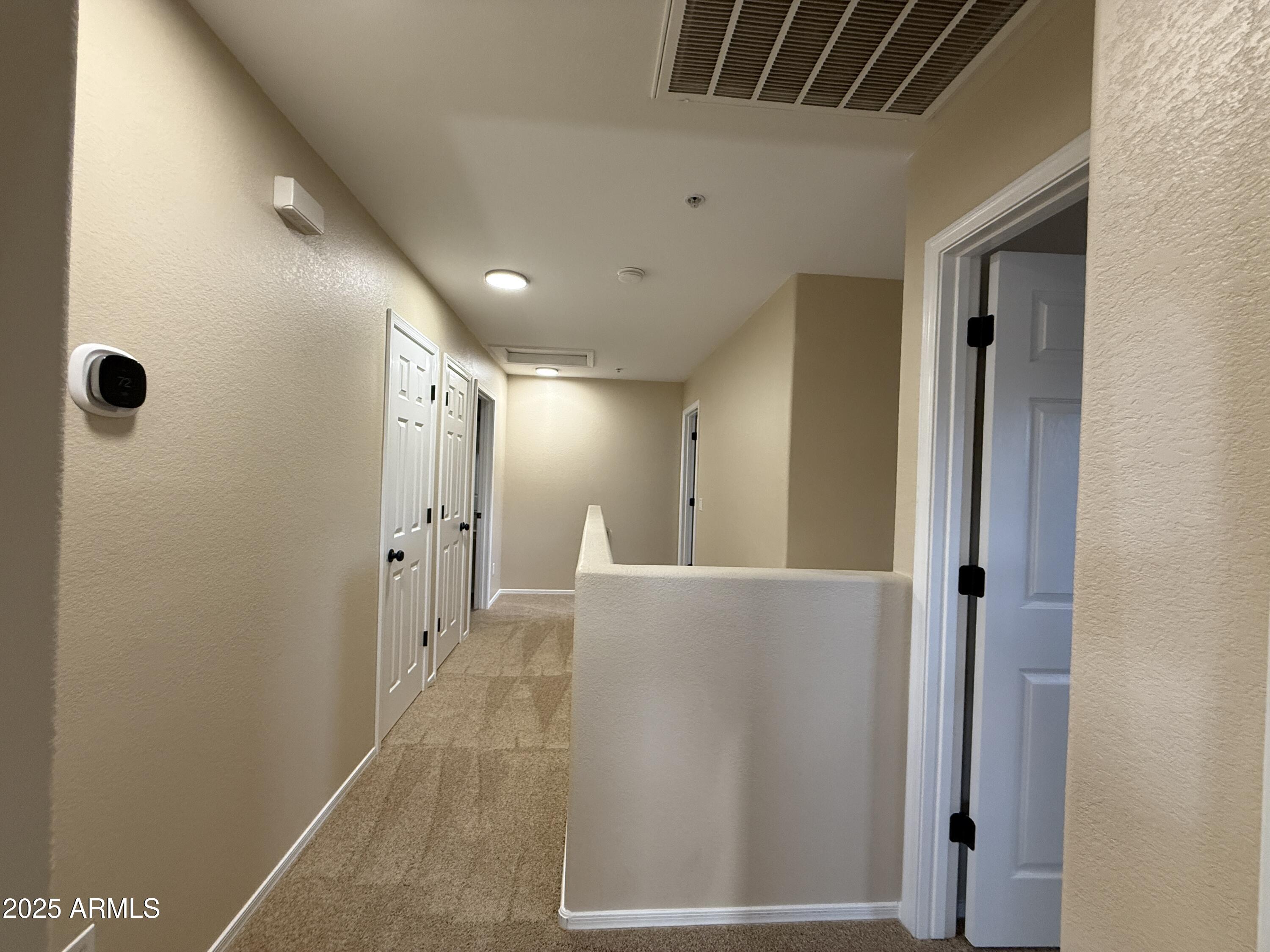 1265 South Aaron, Unit 277 Mesa, AZ 85209 - Photo 27 of 37 a view of a hallway with wooden cabinets