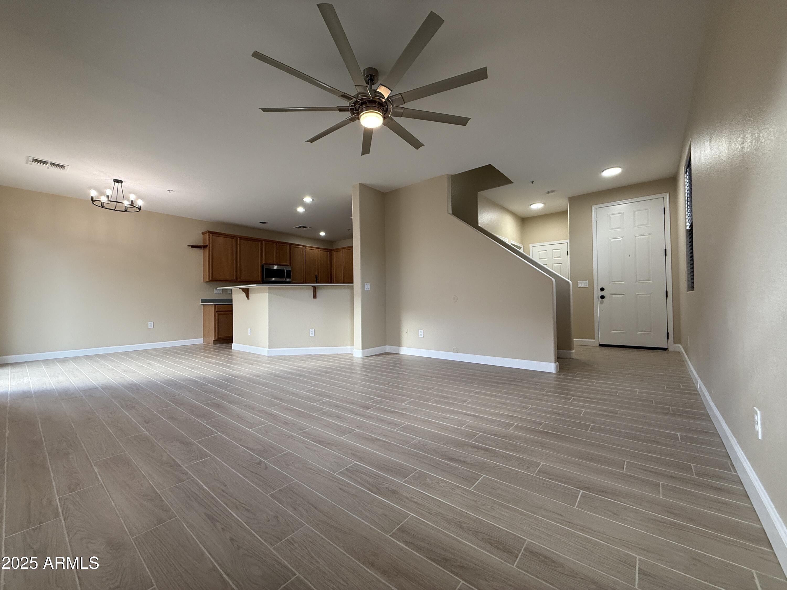 1265 South Aaron, Unit 277 Mesa, AZ 85209 - Photo 32 of 37 an empty space with wooden floor and a ceiling fan