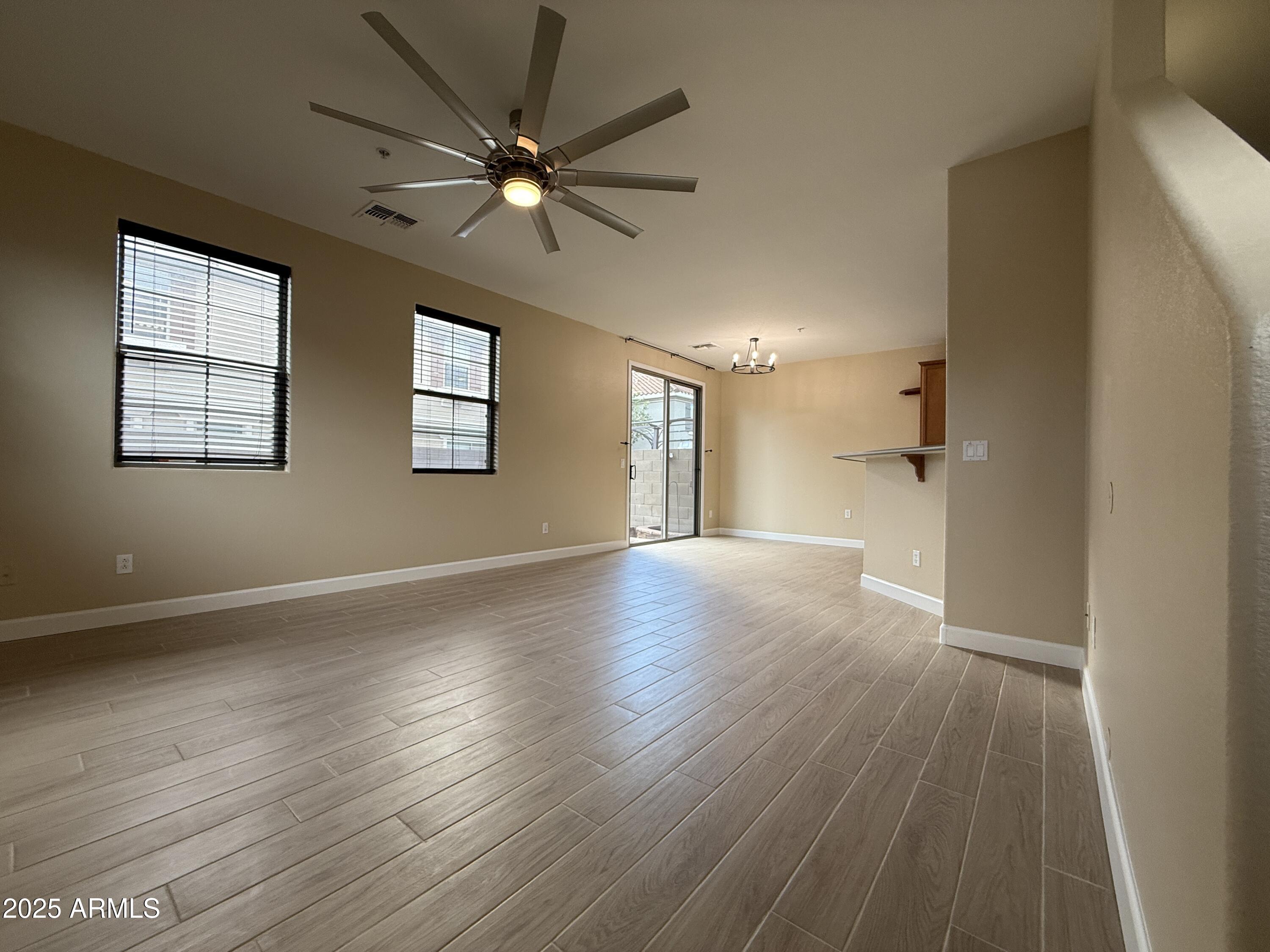 1265 South Aaron, Unit 277 Mesa, AZ 85209 - Photo 33 of 37 a view of an empty room with wooden floor and a window