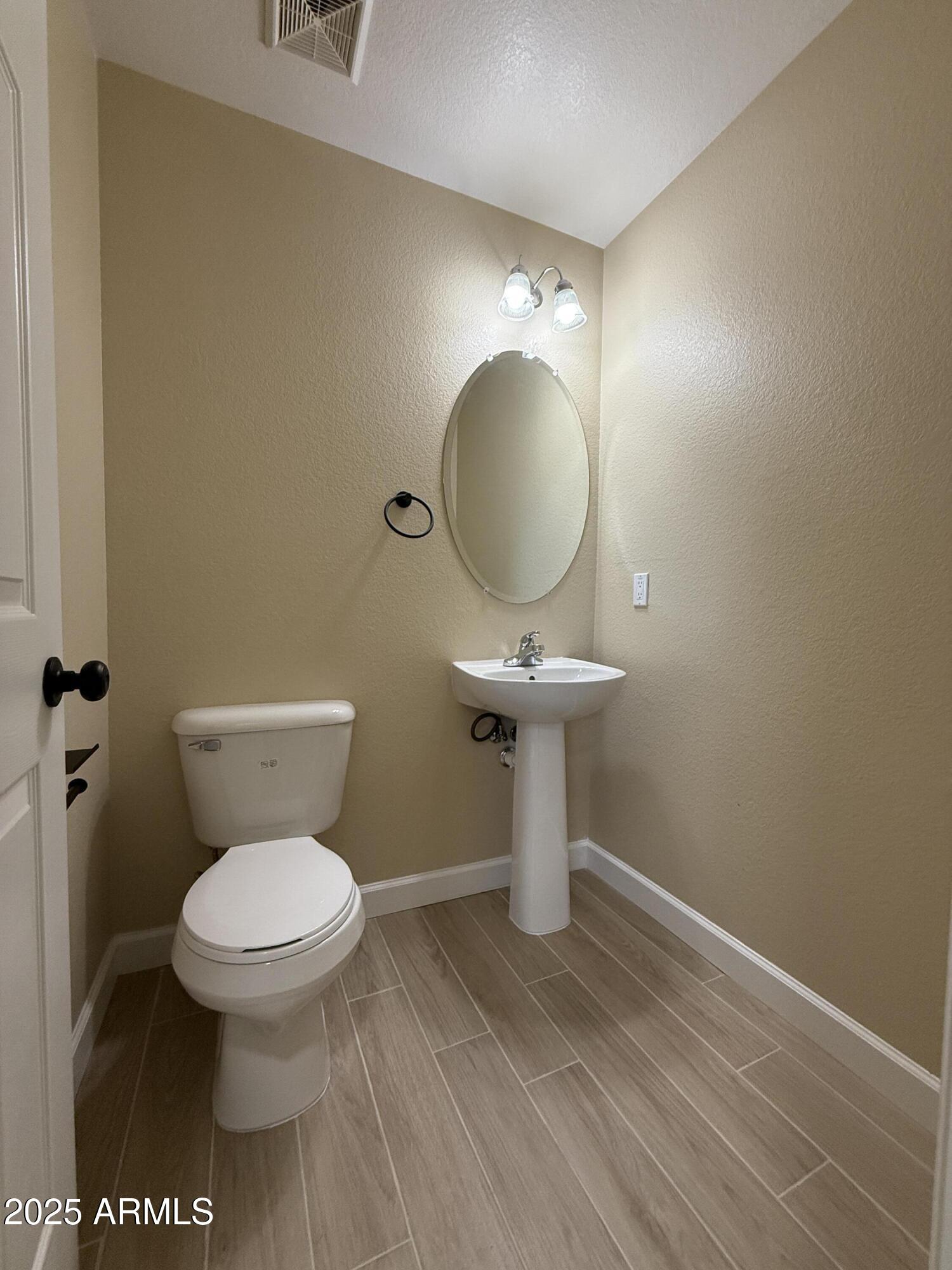 1265 South Aaron, Unit 277 Mesa, AZ 85209 - Photo 34 of 37 a bathroom with a toilet sink and mirror