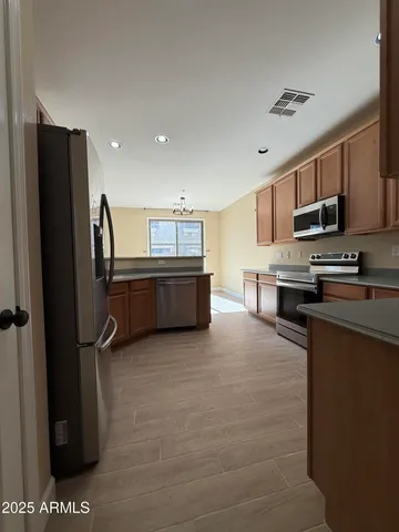 a view of a room with a kitchen and a dishwasher