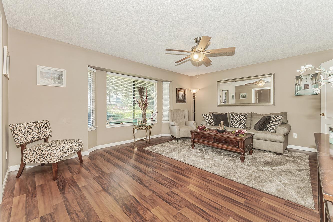1908 East Niles Avenue Fresno, CA 93720 - Photo 4 of 30 a spacious bedroom with a bed a couch and a window