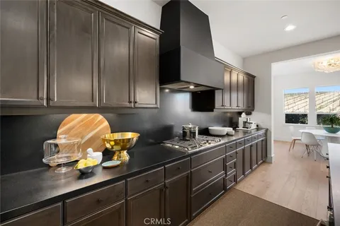 a kitchen with stainless steel appliances granite countertop a sink stove and cabinets