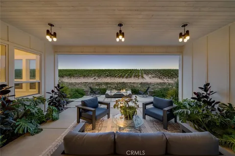 a living room with furniture and a view of kitchen