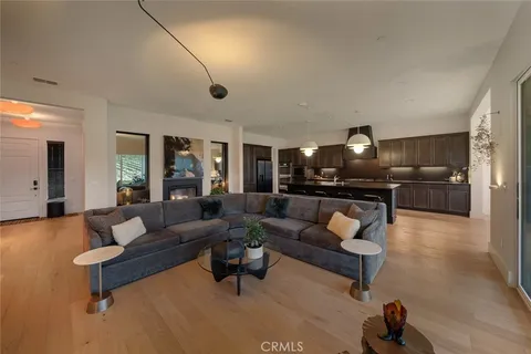 a kitchen with a sink cabinets and wooden floor