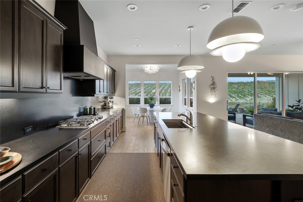 1335 Riley Lane Nipomo, CA 93444 - Photo 16 of 58 a kitchen with stainless steel appliances a stove a sink a microwave a dining table and chairs
