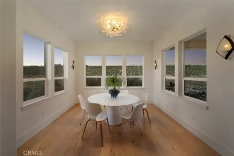 a dining room with furniture a chandelier and wooden floor