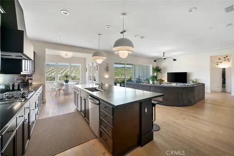 a large kitchen with stainless steel appliances kitchen island granite countertop a large counter top and stainless steel appliances