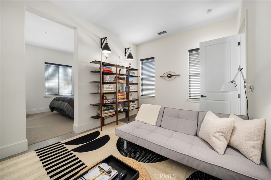 1335 Riley Lane Nipomo, CA 93444 - Photo 28 of 58 a living room with furniture and a book shelf