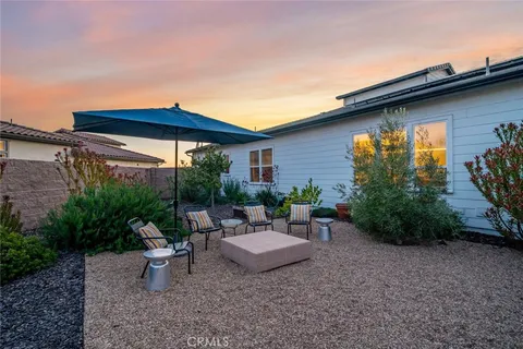 a view of a chairs and table in the patio
