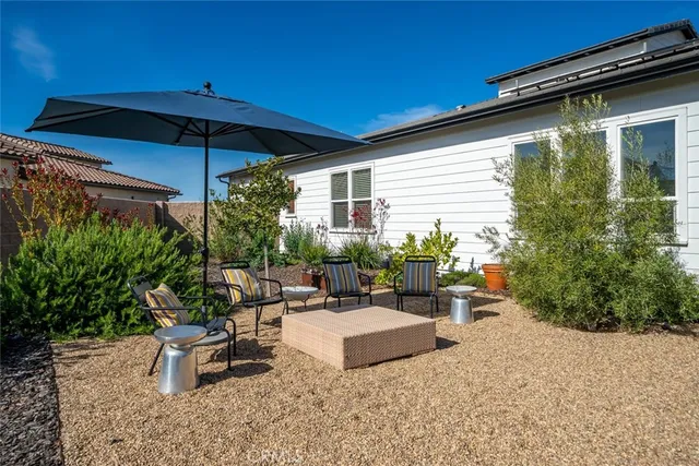 a view of a patio with couches table and chairs and potted plants