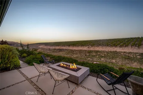 a view of a backyard with sitting area