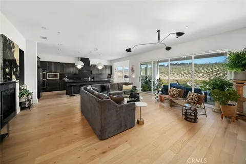 a living room with furniture a flat screen tv and a large window