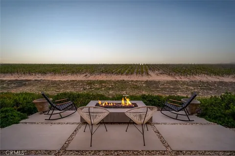 a view of a lake with table and chairs