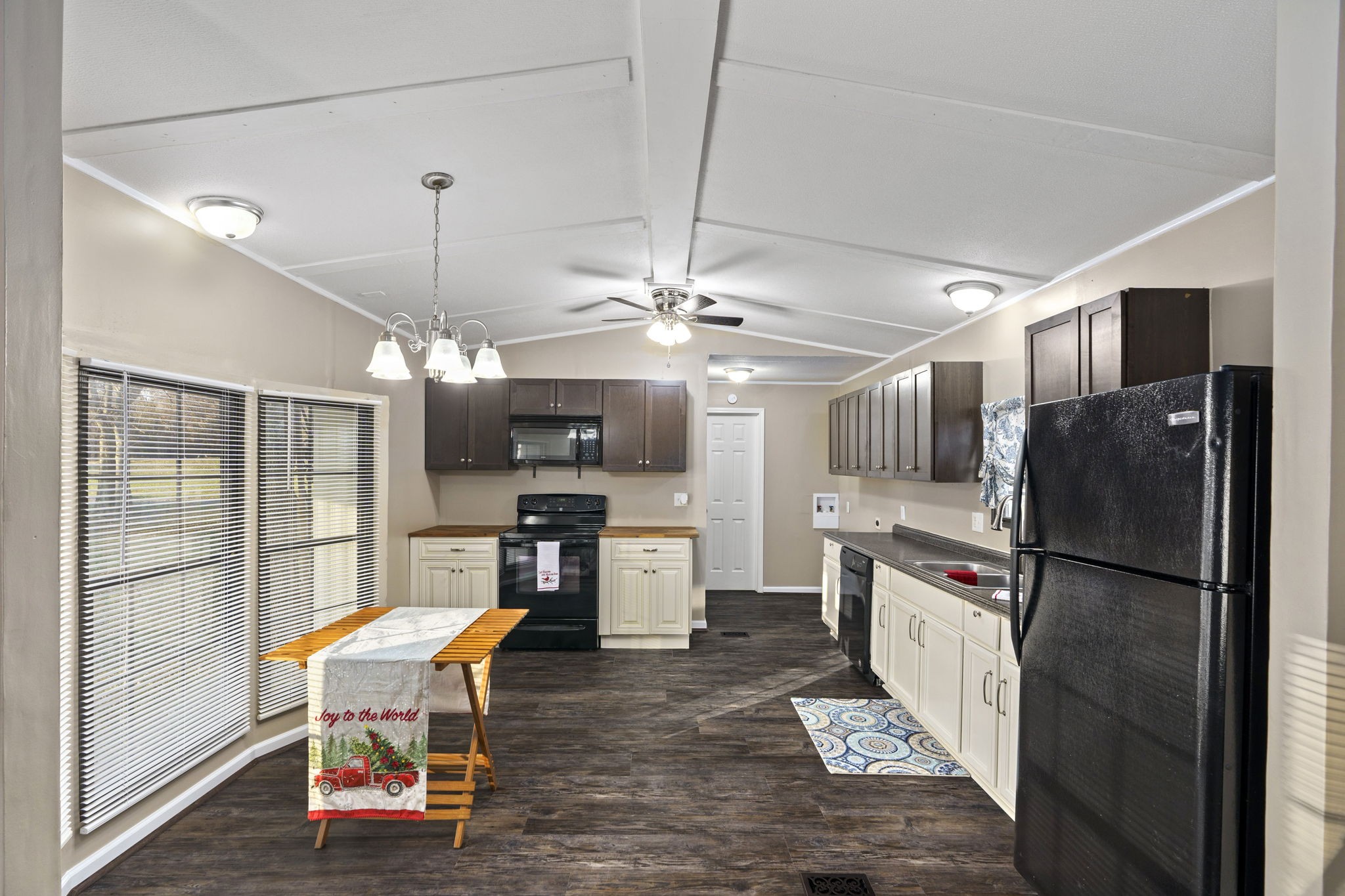 3855 Baggett Road Springfield, TN 37172 - Photo 6 of 42 a kitchen with stainless steel appliances kitchen island granite countertop a refrigerator a stove a sink a dining table and chairs with wooden floor