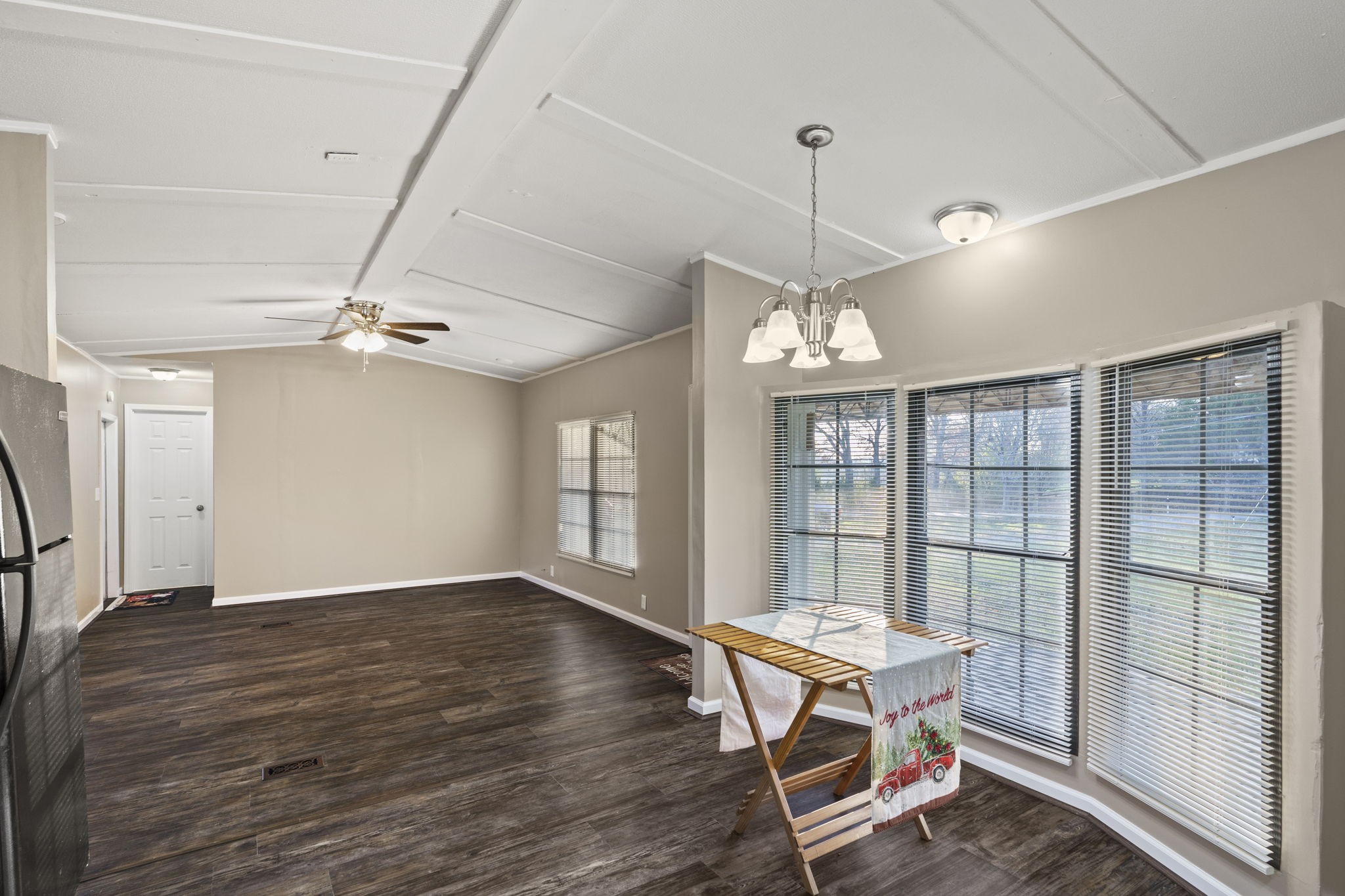 3855 Baggett Road Springfield, TN 37172 - Photo 9 of 42 a dining room with wooden floor a chandelier fan windows and wooden floor