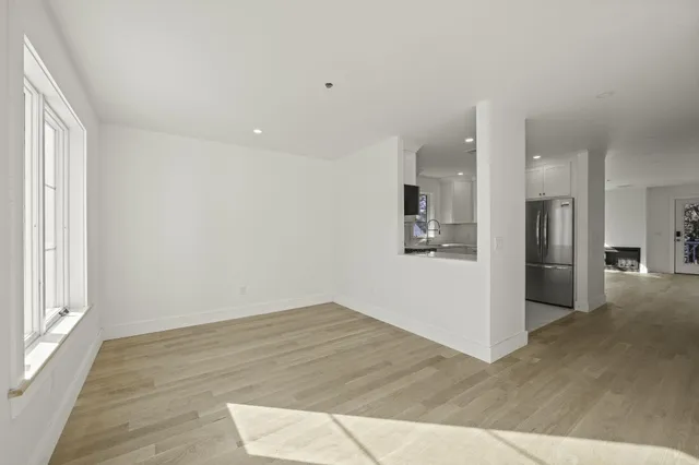 a kitchen with white cabinets stainless steel appliances and a sink