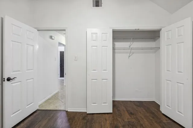 a bathroom with a granite countertop toilet a sink and a bathtub