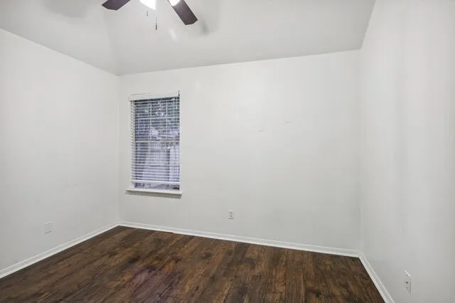 a porch with a table and chairs next to a yard