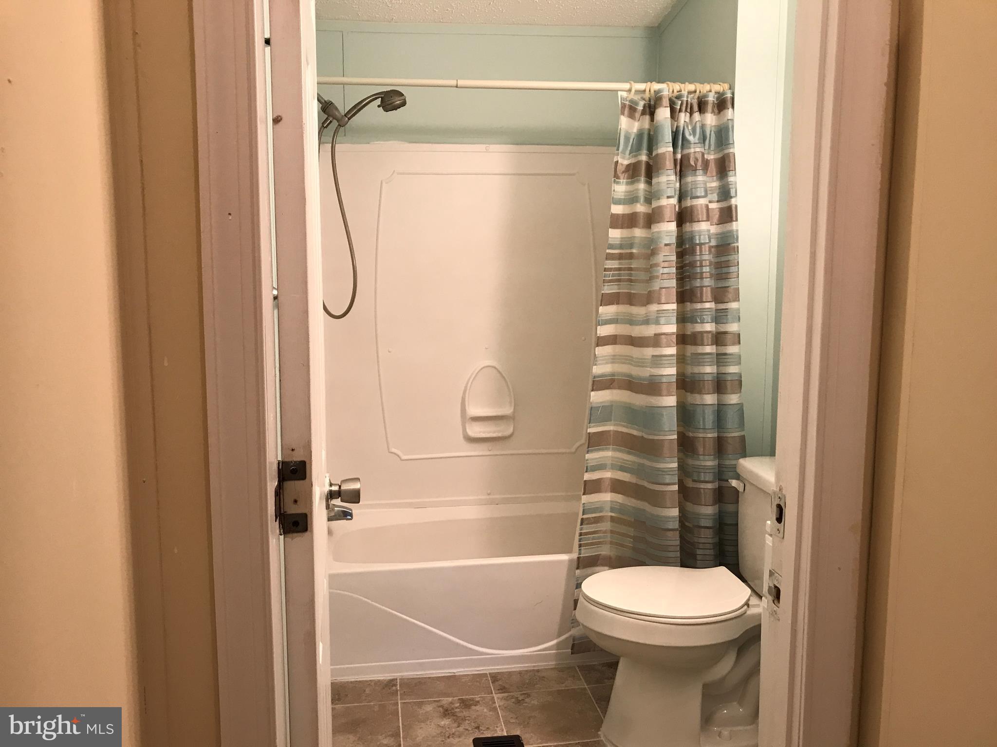 11641 Belfonte Road Bumpass, VA 23024 - Photo 11 of 23 a bathroom with a shower a toilet and a shower