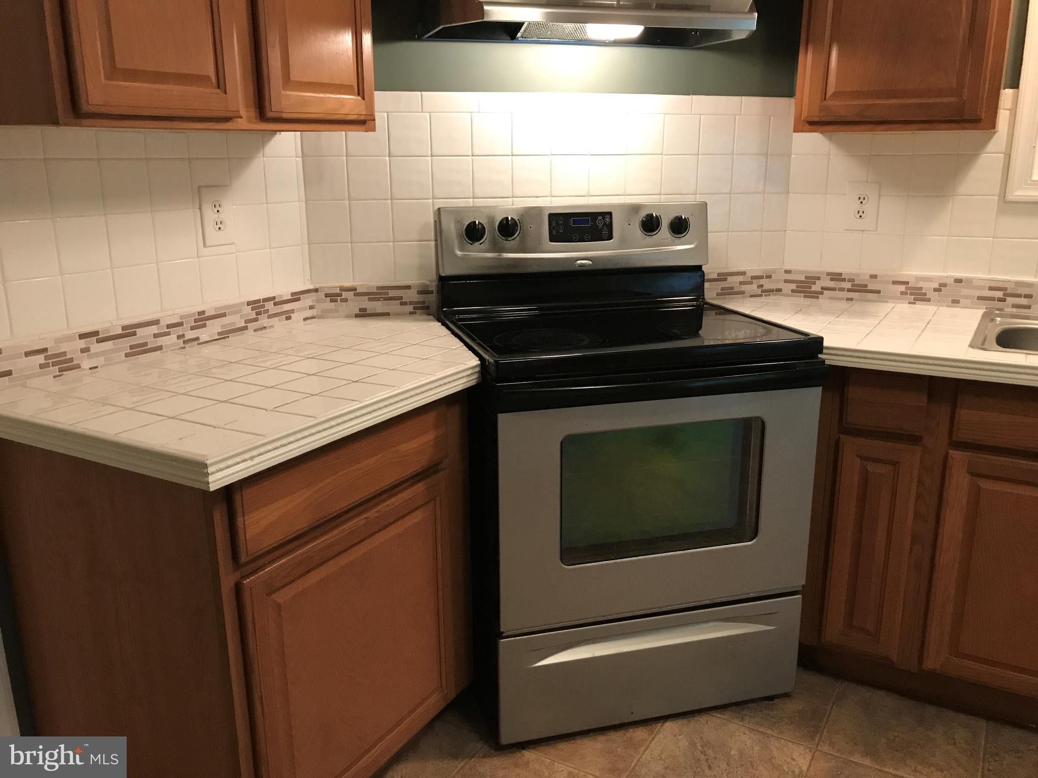 11641 Belfonte Road Bumpass, VA 23024 - Photo 15 of 23 a kitchen with a stove and a microwave