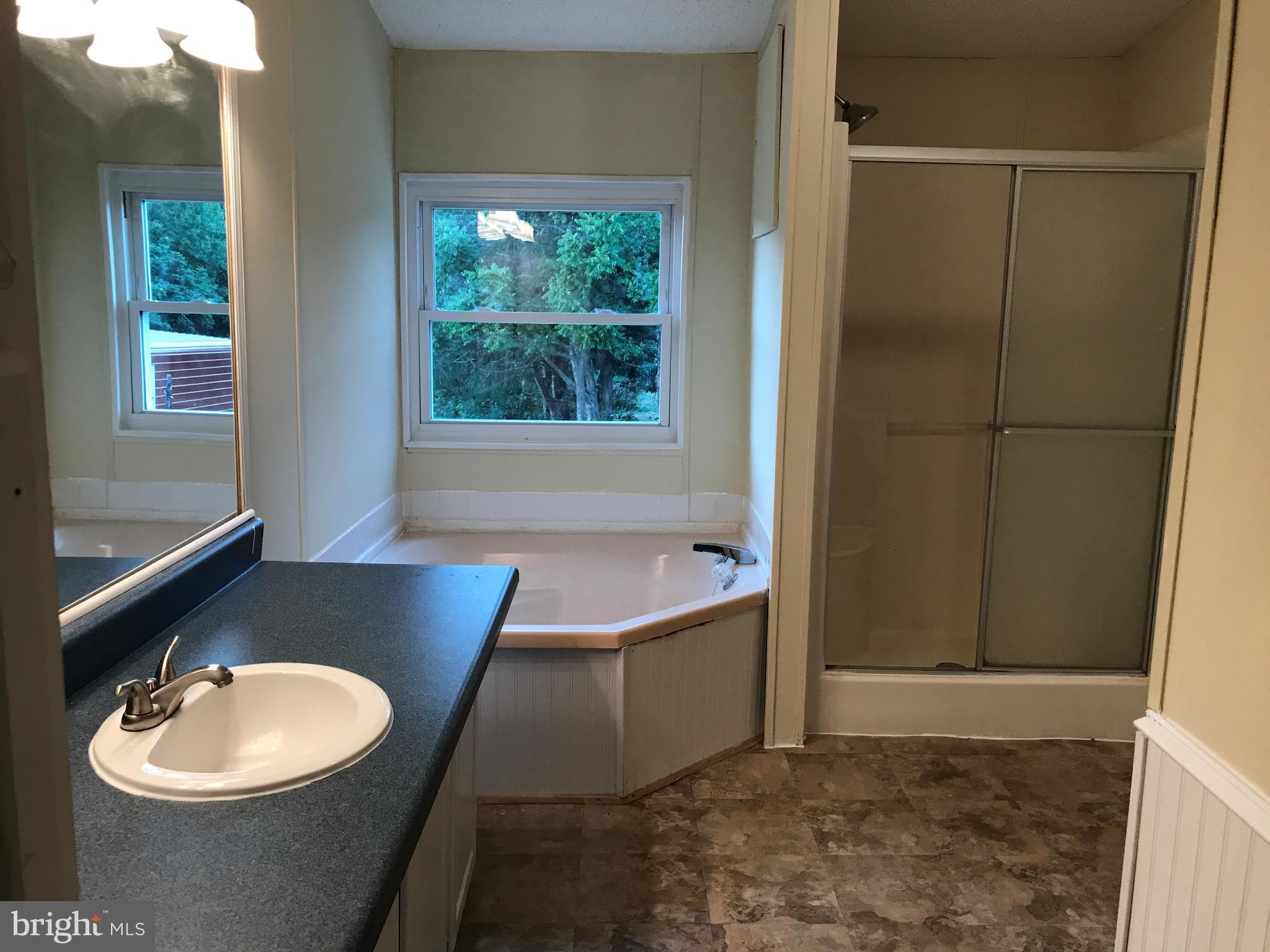 11641 Belfonte Road Bumpass, VA 23024 - Photo 22 of 23 a bathroom with a sink and a mirror
