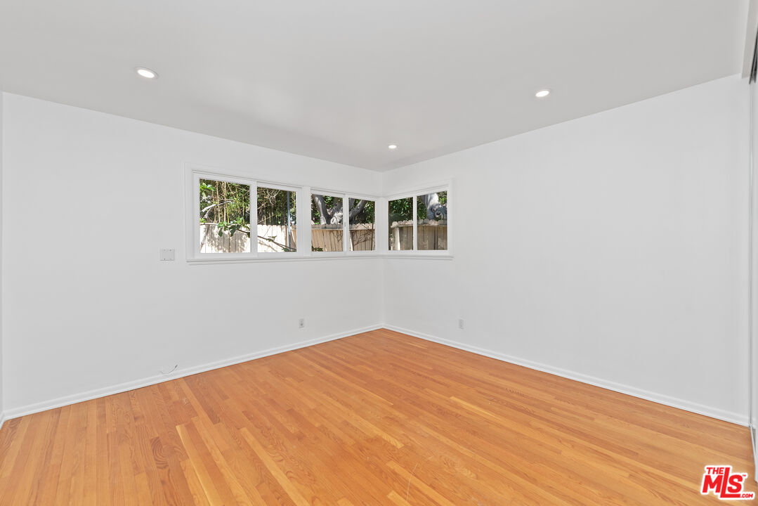 1211 North Kenter Avenue Los Angeles, CA 90049 - Photo 6 of 11 a view of empty room with wooden floor and fan