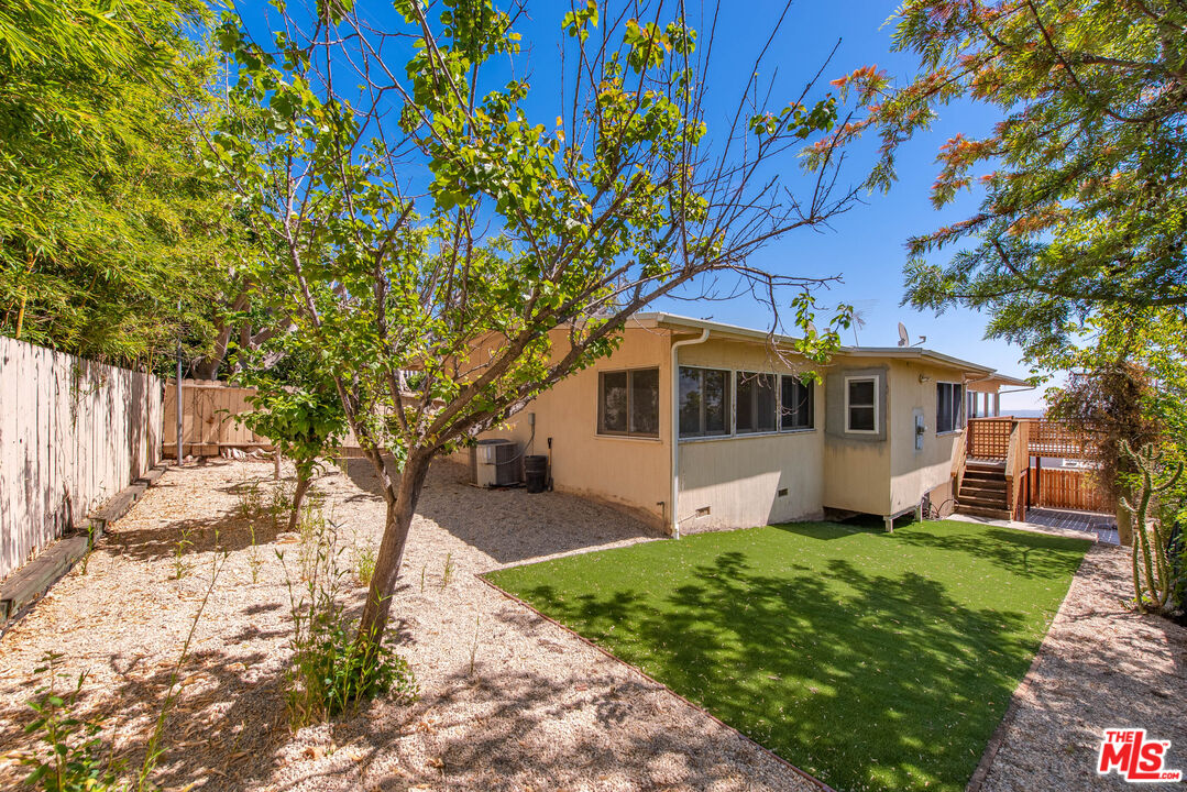 1211 North Kenter Avenue Los Angeles, CA 90049 - Photo 10 of 11 a front view of a house with a garden