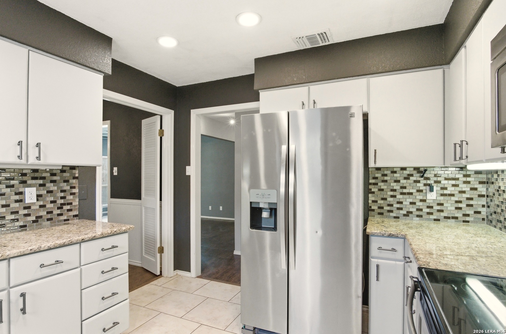 2434 Canyon Rim San Antonio, TX 78232 - Photo 11 of 28 a kitchen with granite countertop a refrigerator and a stove