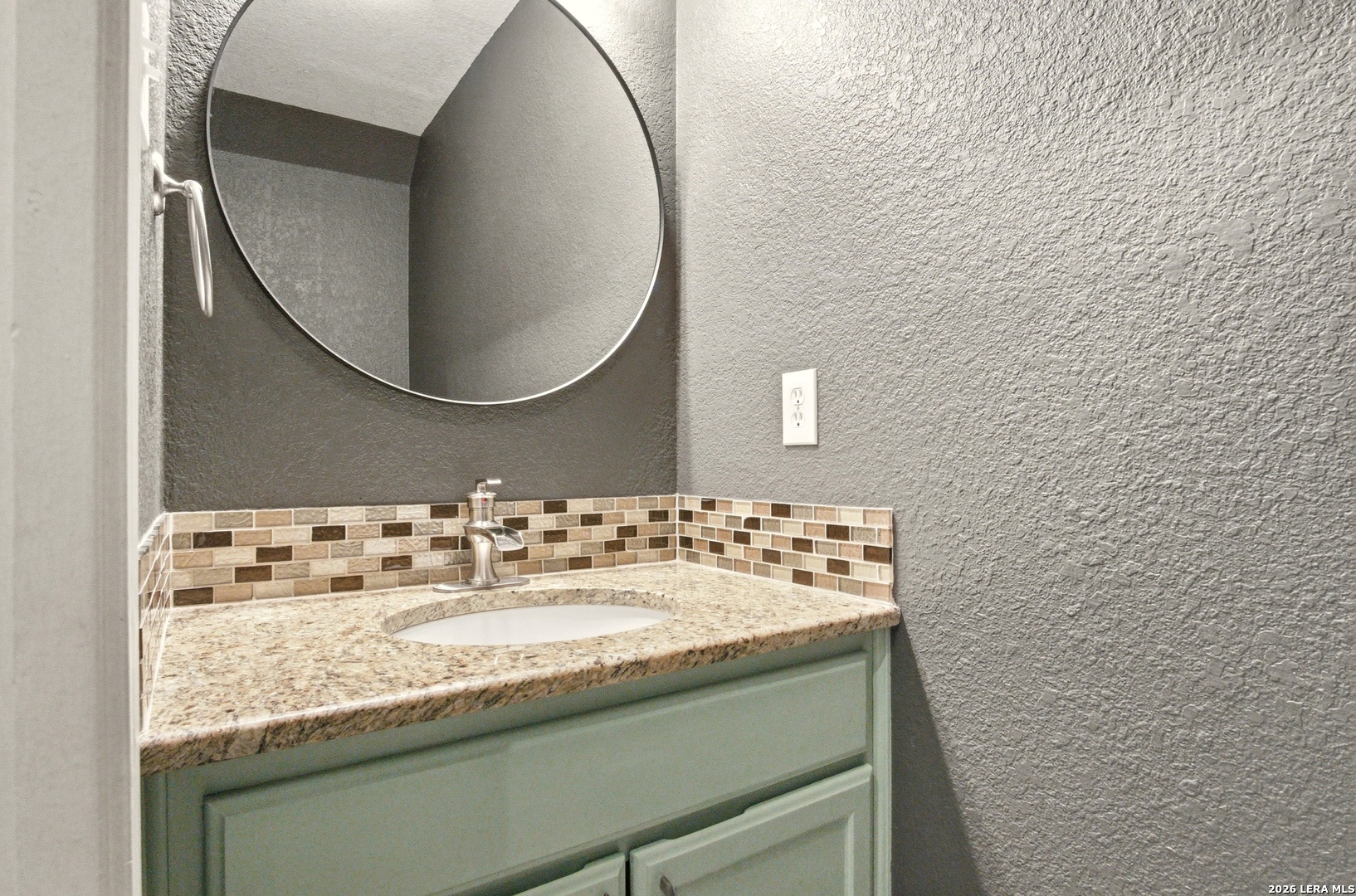 2434 Canyon Rim San Antonio, TX 78232 - Photo 12 of 28 a bathroom with a granite countertop sink and a mirror