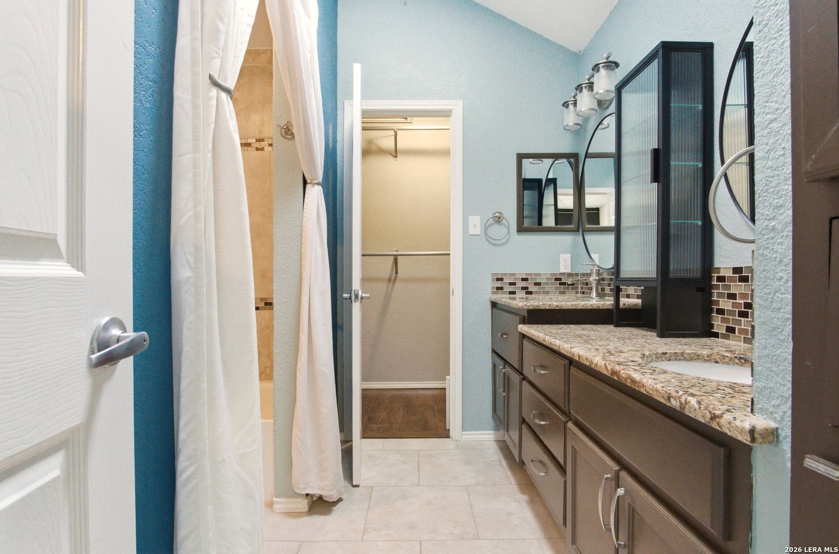 2434 Canyon Rim San Antonio, TX 78232 - Photo 15 of 28 a bathroom with a granite countertop sink and a mirror