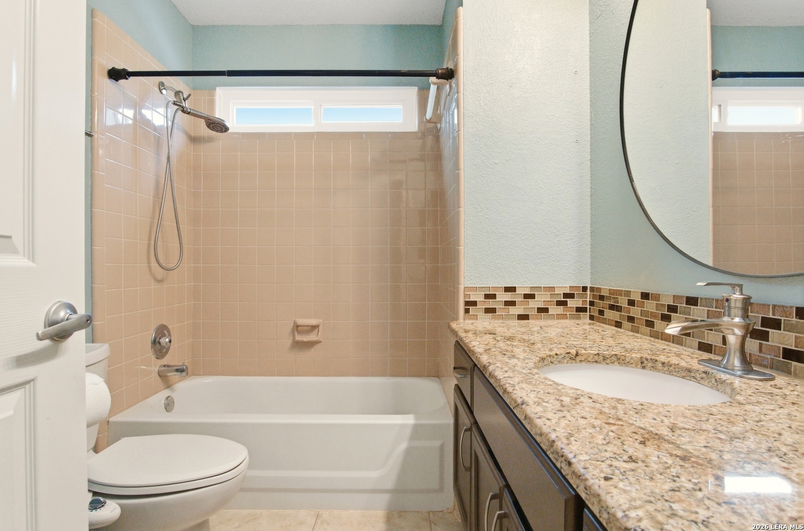 2434 Canyon Rim San Antonio, TX 78232 - Photo 19 of 28 a bathroom with a granite countertop sink a toilet and shower