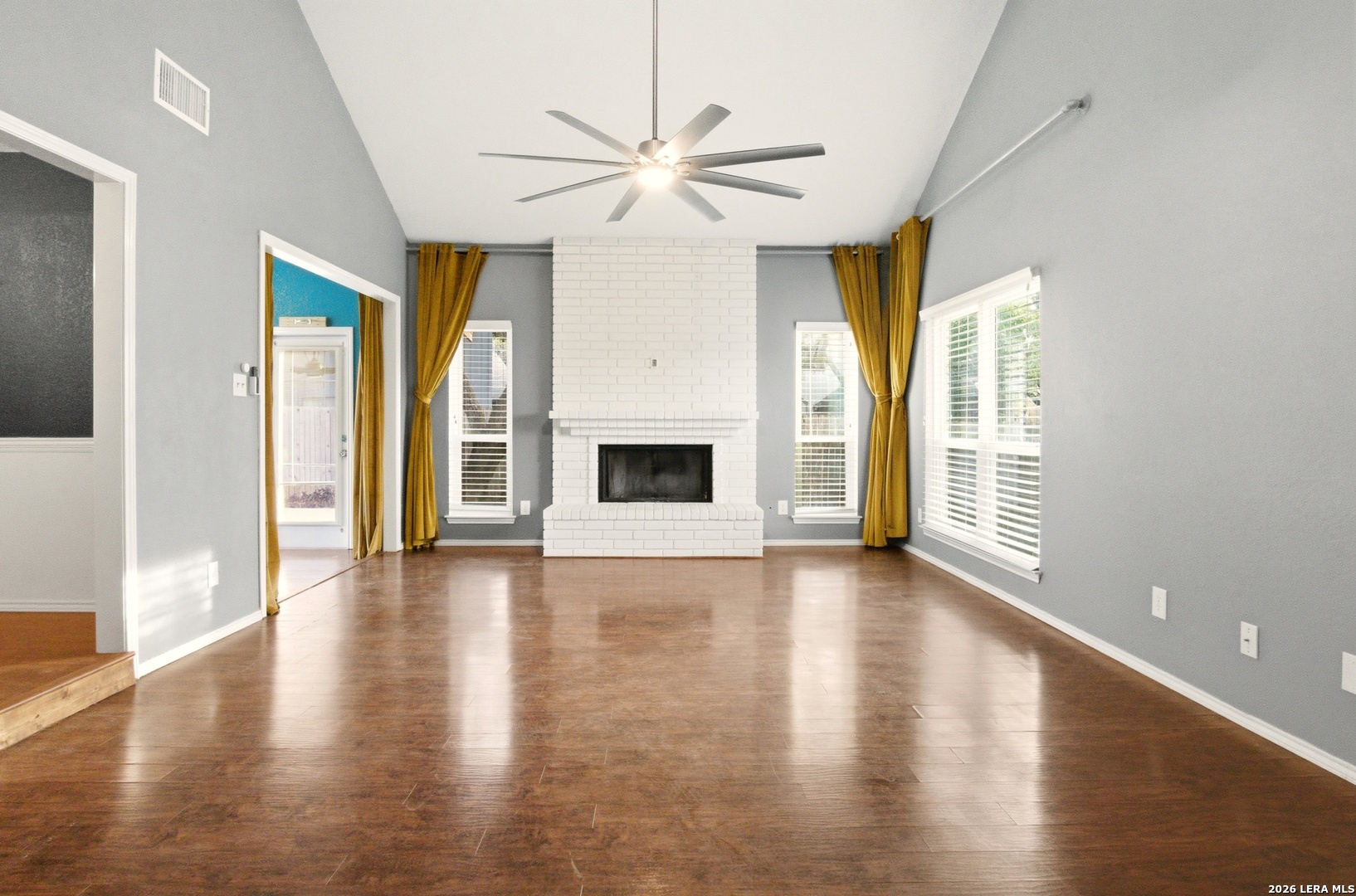 2434 Canyon Rim San Antonio, TX 78232 - Photo 3 of 28 a view of a livingroom with wooden floor a ceiling fan and windows