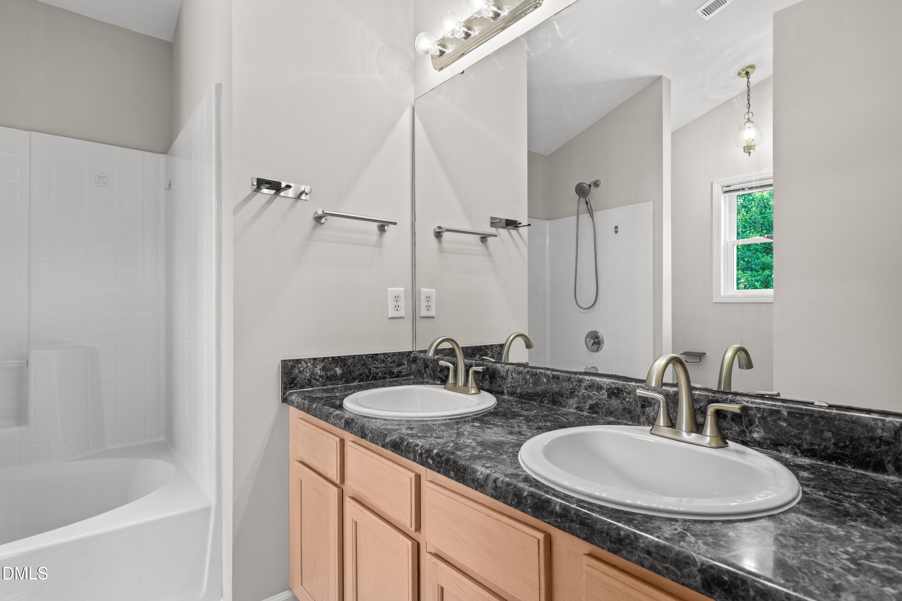 3015 Rennit Court Raleigh, NC 27603 - Photo 22 of 40 a bathroom with a granite countertop sink and a mirror