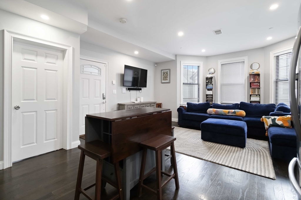18 Albion Street, Unit 2 Boston, MA 02119 - Photo 2 of 22 a living room with furniture a wooden floor and a flat screen tv