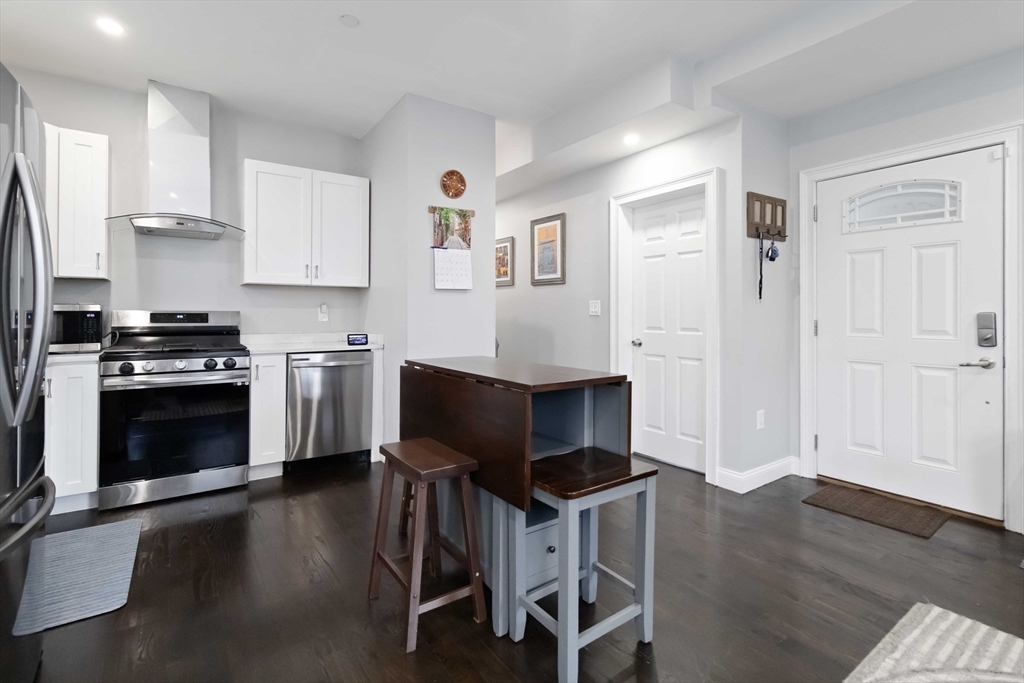 18 Albion Street, Unit 2 Boston, MA 02119 - Photo 3 of 22 a kitchen with stainless steel appliances a stove a sink cabinets and a refrigerator