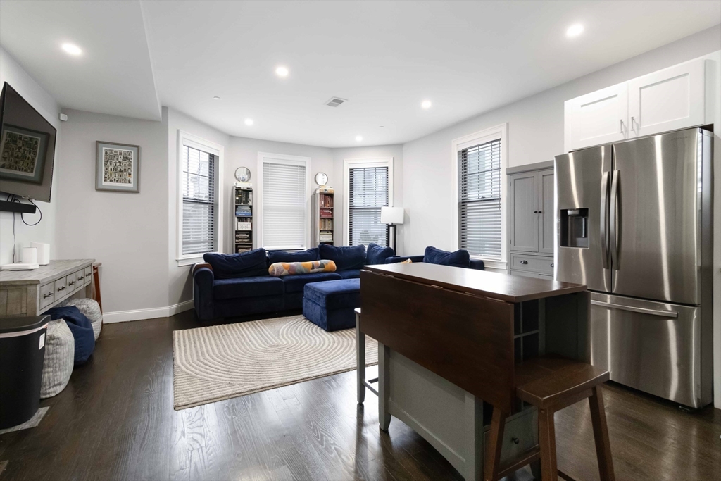 18 Albion Street, Unit 2 Boston, MA 02119 - Photo 4 of 22 a living room with stainless steel appliances granite countertop a refrigerator a sink dishwasher a stove and a refrigerator with wooden floor